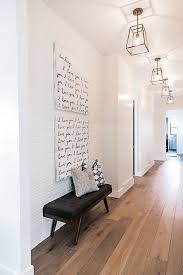 Black And White Brick Wall Design Hardwood Floor And Painted Brick Accent Wall Hall Features Wide Plank White Oak Hardwood Floors Painted Brick Accent Walls Hallway Designs White Brick Walls