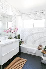 Mid Century Modern Bathroom With White Subway Tiles On The Walls And Black Hexagon Ones On The Fl Relaxing Bathroom White Bathroom Designs Bathroom Inspiration
