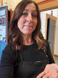 Behind the chair going