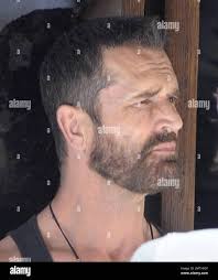 EXCLUSIVE!! Openly gay actor Rupert Everett shows off his beard as he  relaxes at an outdoor cafe with friends in Soho during the 2010 London Gay  Pride Parade. London, UK. 07/03/10 Stock