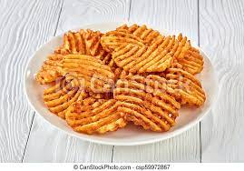 These are basically potato pancakes (a.k.a. Crispy Potato Waffles Fries Top View Crispy Potato Waffles Fries Wavy Crinkle Cut Criss Cross Fries On A White Plate On Canstock