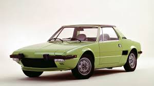 It is a 4 cylinder engine with a 4 speed transmission. Drive Flashback 1973 Fiat X1 9