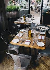 Slate, stone, or marble cutlery trays a most unique table setting idea is to have a cut slab of stone, slate, or marble for customers to place their cutlery on. Chris Ozer Rustic Kitchen Design Restaurant Interior Rustic Kitchen