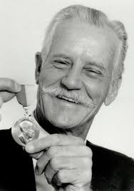 Collector of history: Louis Ricci, of North York, holds up a scrapbook with  a picture of a 1936 Chrysler advertisement.