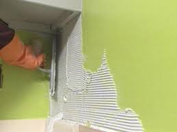 installing a glass tile backsplash in a