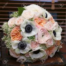 Love the berries and the purple flower.would have no pink flowers but maybe some red and white. Bride Holds Wedding Bouquet Of Pink Roses And White Anemone And Stock Photo Picture And Royalty Free Image Image 98049060
