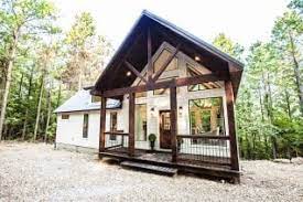 Rustic elegance cabin, casual, relaxing, inviting feel complete with red & gray plaid bedding with fluffy feather comforter. Oklahoma Cabin Rentals Hidden Hills Cabins Hidden Hills Cabins
