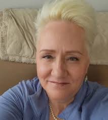 What hairstyle and color suit a 64-year-old woman?