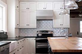 White kitchen cabinets are finished with a white marble countertop located against a white marble arabesque backsplash accented with gray grout and mounted beneath white upper cabinets placed beside a. Traditional Family Home Traditional Kitchen Toronto By Rebecca Melo Houzz