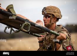 Staff Sgt. Abel Carlos, Combat Medic Specialist, 25th Infantry Division,  carry a skid litter during an physical training exercise for the Army's  Best Medic Competition. Twenty-two two-Soldier teams from all around the