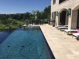 Travertine Pavers Pool Deck Loungers Wall Lamps Stone Tiles Patio Low Back Chairs Round Table Trees Decorat Travertine Patio Travertine Pool Travertine Outdoor