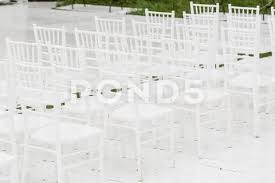 Photograph Rows Of Empty White Chairs Sitting On A Wooden Floor Wedding Chairs With 105615827 Wedding Chairs White Chair