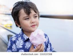 Kid Holding Cotton Candy Photos, Images and Pictures