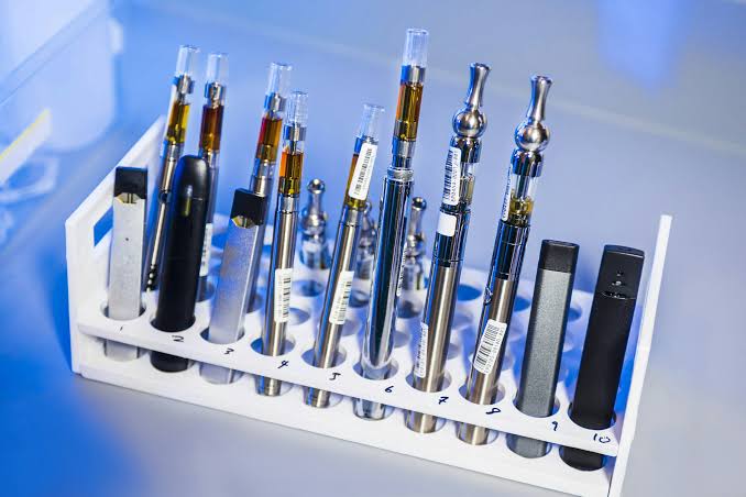 Various vaporizing devices displayed in a clean laboratory setting, AI generated