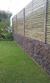 Plants make gabion baskets more powerful by filling the gaps. Gabions An Incredible Find For Every Owner Of The Suburban Area My Desired Home Fence Design Privacy Fence Designs Gabion Fence