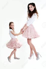 Mother daughter fashion mom daughter mother and child daughters mother daughter matching outfits outfits madre e hija mother pictures cherry dress dress red. Mother And Daughter In Same Outfits Posing On Studio Kissing Stock Photo Picture And Royalty Free Image Image 44783802