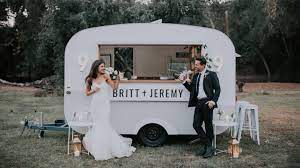 A beautiful centre stage decoration shows off use embroidered colourful umbrellas and dangle them in the background. A Guide To All White Wedding Decor