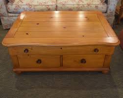 The glass top of our driftwood flats cocktail table is the perfect way to showcase the design's rustic base composed of a series of wooden x's lined up. Stanley Pine Coffee Table New England Home Furniture Consignment
