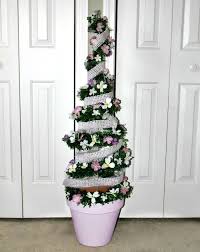 As you go, wrap single pieces of the branches around the horizontal support rings of the tomato cage. How To Make A Spring Topiary Tree With A Tomato Cage Our Crafty Mom