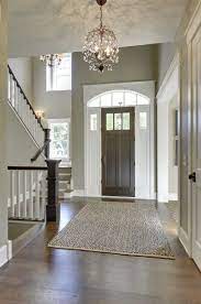 Lucidce chandelier farmhouse foyer lighting 6 lights oil rubbed bronze metal lantern pendant light fixtures for kitchen island entryway hallway dining room 4.5 out of 5 stars 226 $69.99 $ 69. Foyer With A Hardwood Flooring And A Rug Along With Gray Walls Lighted By A Charming Chandelier Foyer Lighting Foyer Lighting Fixtures Entryway Chandelier