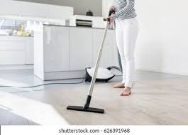 Filling the void between broom and vacuum cleaner, a carpet sweeper features rotating brushes that sweep up dirt and debris and deposit it into a dirt tray that you can. Woman Using Vacuum Cleaner Kitchen Stock Photo Edit Now 626391968