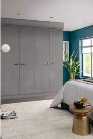 Grey Fitted Wardrobes Go Perfectly With Bedroom Wall Painted In Classic Blue 2020 Hottest Shades F Gray Bedroom Walls Fitted Bedrooms Fitted Bedroom Furniture