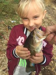 Daughter catches large bass in backyard pond