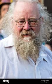 Broadstairs Folk Week Festival. Face portrait, Madcap Morris senior man,  grey hair, beard and glasses. Facing viewer with eye-contact Stock Photo