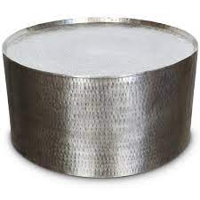 The tactile surface will add texture and shine to your interior space, and looks gorgeous styled up with flowers or candles. Rotonde Silver Hammered Metal Industrial Round Coffee Table