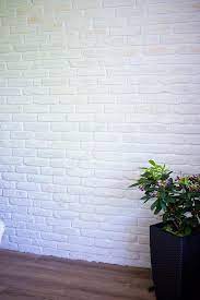 The rustic charm of our painted white brick wallpaper mural shines through the cracked and chipped paint of the brickwork design. Urban Feature Wall Using Rustic White Brick Slips And Bright White Mortar Painted Brick Walls Brick Interior Wall White Brick