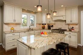 White Kitchen Cabinets Yellow River Granite Countertops Mini Pendant Lights Over Kitchen Island Granite Countertops Kitchen Kitchen Renovation Kitchen Remodel