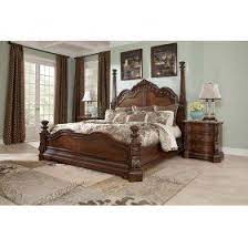 With The Traditional Dark Cherry Stain Finish Flowing Beautifully Over The Elaborately Ornate Details The Ledelle Ashley Bedroom Bed Furniture Bedroom Sets
