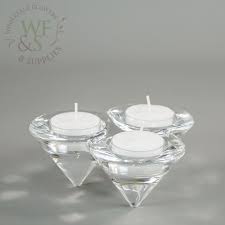 From simple lantern and pillar designs to ornate tiered candelabra, we offer decorative ways to hold your fire on the table, mantle and more. Tri Cone Shaped Contemporary Style Thick Glass Candle Holder Wholesale Flowers And Supplies Wholesale Flowers And Supplies