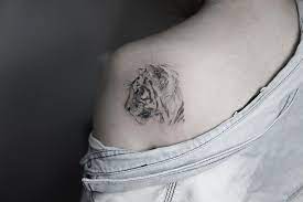 15 Stunning Lion And Tiger Tattoos That You Ll Want On Your Body Tiger Tattoo Small Small Shoulder Tattoos Tiger Tattoo
