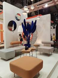 Neutral Tones Contrast With Strong Blue Plant Feature Milan Furniture Fair Exhibition Stand Exhibition Stand Design Furniture Design Showroom Design
