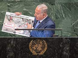 A coalition of eight parties came a demonstrator wearing a mask showing benjamin netanyahu's face holds up his handcuffed hands during a rally celebrating the new coalition. At Un Assembly Israel S Netanyahu Claims Iran Harboring Secret Nuclear Site Un News