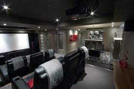 This modern media room boasts a theater space with sectional sofa seats along with a small bar on the side set on the red velvet carpet flooring matching the red elegant walls. 80 Home Theater Design Ideas For Men Movie Room Retreats