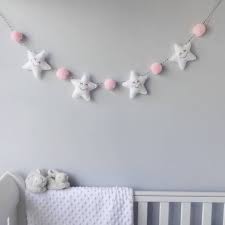 This diy wall decor idea for baby just could not be any cuter. Star Garland With Honeycomb Pom Poms Diy Baby Stuff Baby Crafts Baby Decor