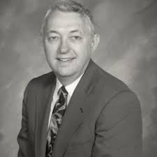 Biology professor Sami Saad with student in greenhouse