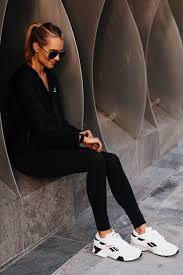 Blonde Woman Wearing Reebok Black Windbreaker Reebok Black Leggings Reebok Aztrek White Sneakers Fashion J Fashion Jackson Reebok Outfit White Fashion Sneakers