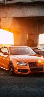 Audi iphone wallpaper for more audi iphone wallpapers cl 1280 853. Orange Audi Car Front View Sunlight Highway 1242x2688 Iphone 11 Pro Xs Max Wallpaper Background Picture Image