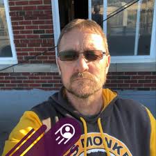 A neatly installed plumbing system under a kitchen sink. The drain assembly  includes PVC pipes connected with fittings, leading to a vertical pipe for  wastewater drainage. The P-trap is visible, which prevents
