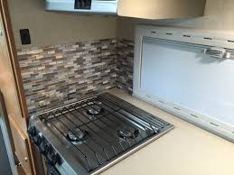 16 rv hacks that make road trips much more bearable. Rv Kitchen Backsplash Modification Truck Camper Adventure