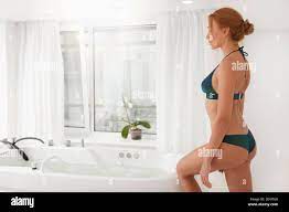 Gorgeous woman with stunning sexy body getting into a whirlpool bathtub at  spa center. Attractive female entering hydro massage bath at beauty salon  Stock Photo - Alamy