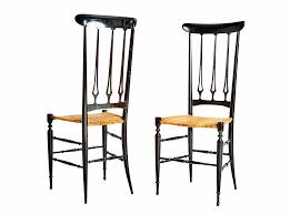 A Pair Of Italian Chiavari Chairs The Black Ebonized Frames Stand Tall Sleek And Slender With Graceful Lines And Cle Chiavari Chairs Modern Side Chairs Chair