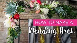 Leafy greens and white flowers are used to bring color and life. How To Wedding Arch Diy Wedding Arch Wedding Arch Arch Flowers