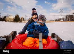 Mother son on snow tube hi-res stock photography and images - Alamy