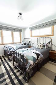 A madras quilt at the foot of the bed brings all the accent colors together. Modern Big Boys Bedroom Bright Green Door