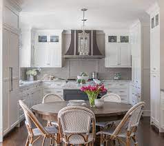 This aspect yields amazing looks with peculiar functions. Classic White Kitchen With Grey Backsplash Kitchen Layout White Tile Kitchen Backsplash Classic White Kitchen