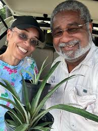 Audrey Mackey and I are smiling for the bounty of Saturday's Meet & Greet  courtesy of Denise R. Jacobs, Angela Yvette, and Catherine Marco,,, coveted  Antigua Black pineapple plants, a plantain and